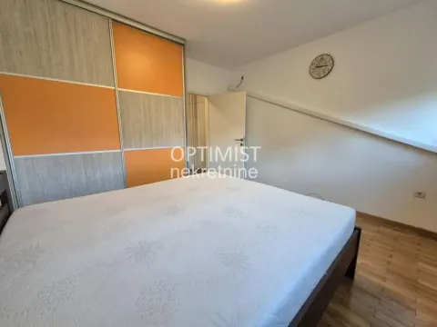 Furnished bedroom with a double bed and a large fitted wardrobe. - image 5