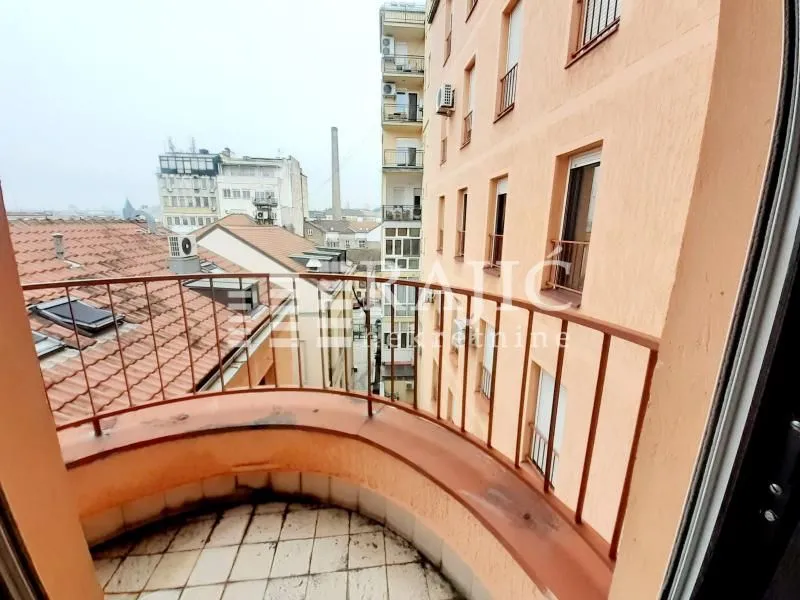 View from the semi-circular balcony overlooking surrounding buildings and the city center.