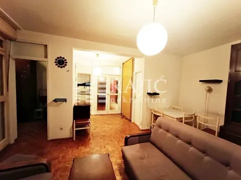 Living room with a sofa and dining table. - image 5