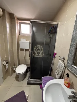 Bathroom equipped with a shower cabin, toilet, and washbasin. - image 10