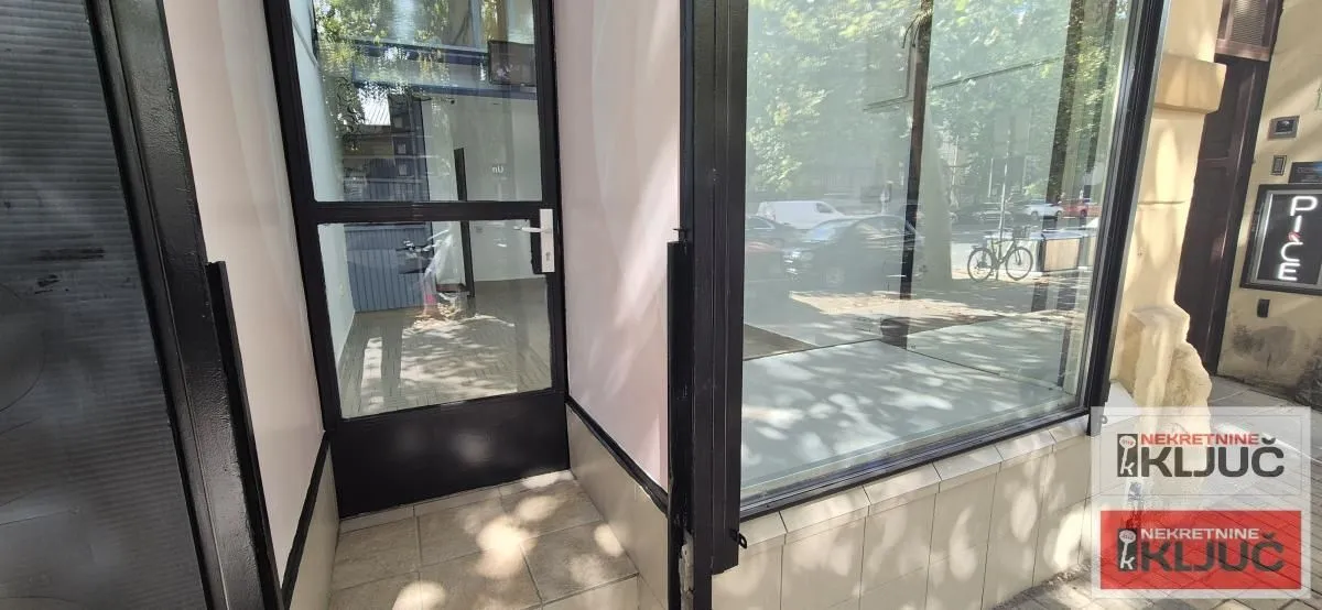 Entrance to the commercial space with a glass shopfront and door.