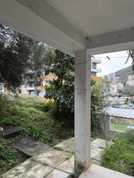 Covered terrace with a view of surrounding greenery and buildings. - image 3