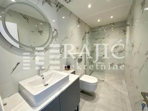 Modernly equipped bathroom with a walk-in shower and sink.