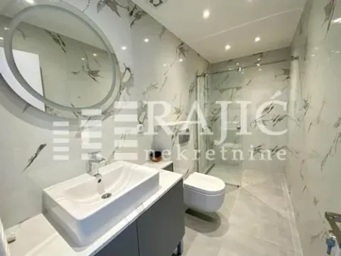 Modernly equipped bathroom with a walk-in shower and sink. - image 9