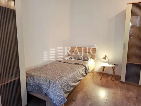 Furnished bedroom with a bed and wardrobe. - image 6