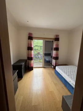 Bedroom with a bed, wooden flooring, and access to the terrace. - image 9