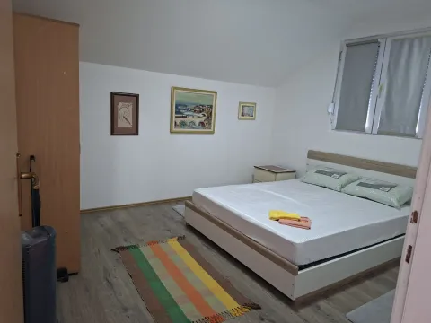 Furnished bedroom with a double bed, wardrobe, and wall art. - image 5