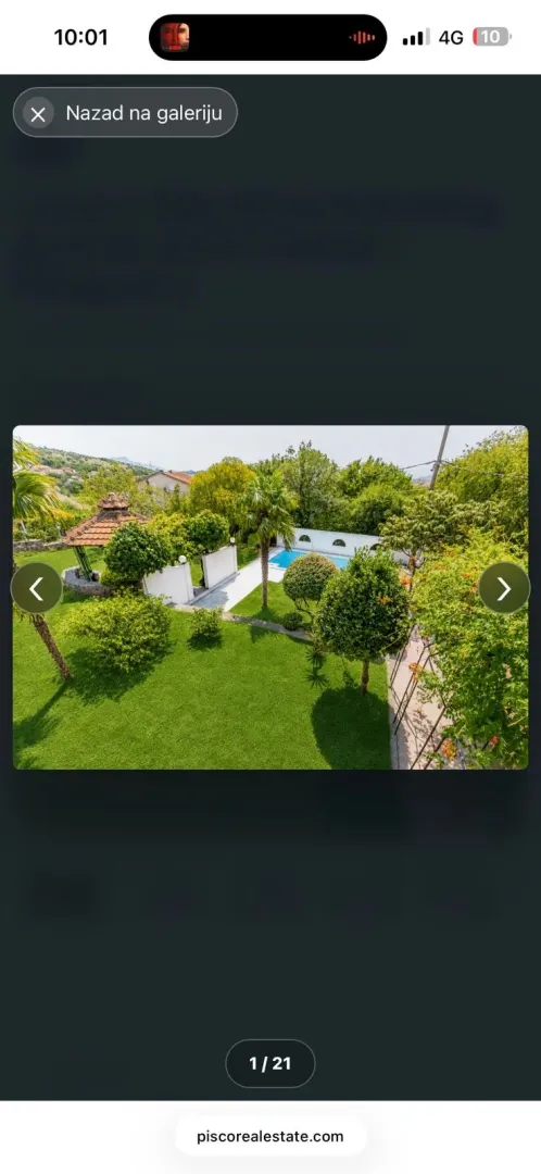 Elevated view of a landscaped yard with a swimming pool and greenery.