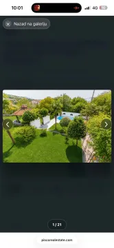 Elevated view of a landscaped yard with a swimming pool and greenery. - image 10