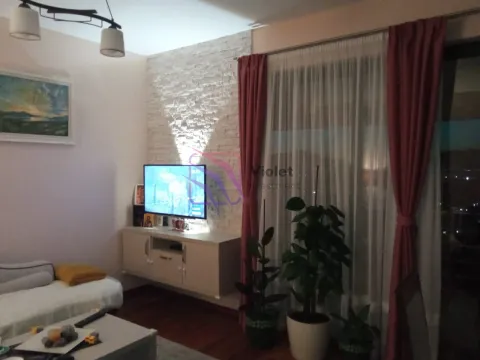 Dnevna soba sa televizorom, ukrasnim kamenom na zidu i prozorom sa zavjesama. - image 12