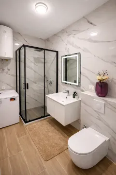 Moderne opremljeno kupatilo sa tuš kabinom, umivaonikom i WC šoljom. - image 11