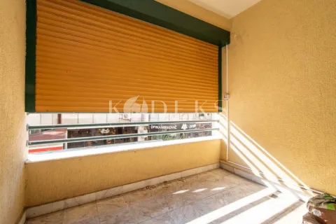 Covered balcony with a lowered roller shutter and street view. - image 14