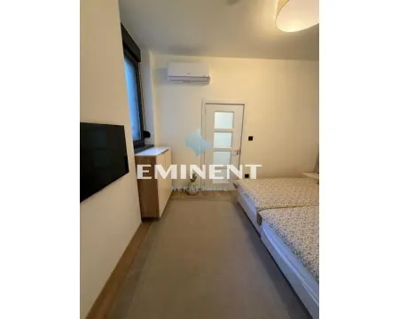 Bedroom with a bed, television and air conditioning. - image 9