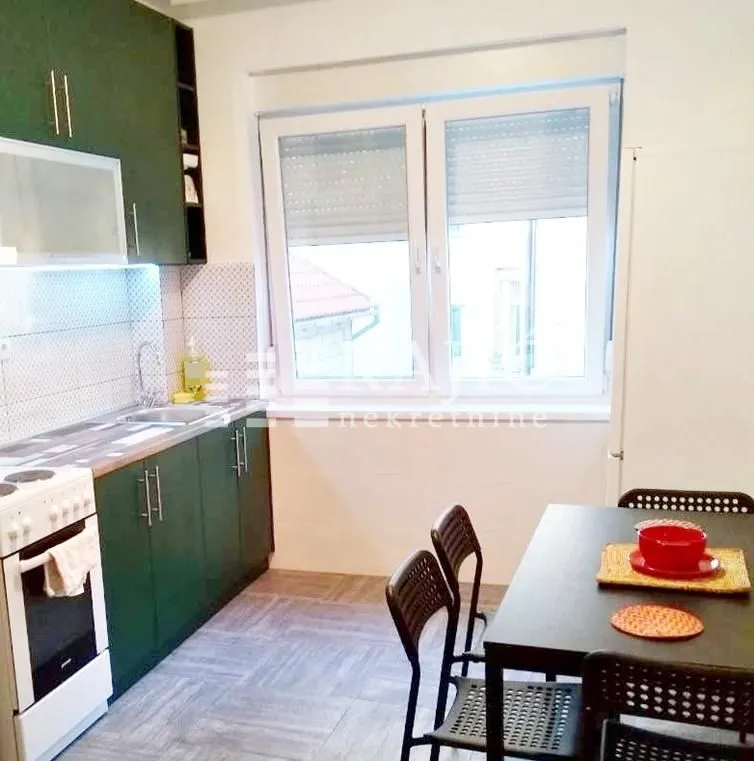 Kitchen with dining area and window.