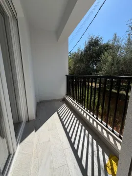 Svijetli balkon sa crnom ogradom i pogledom na zelenilo. - image 11