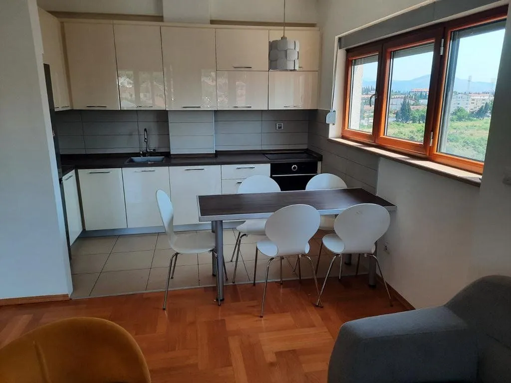 Kitchen with a dining table and chairs near the window.