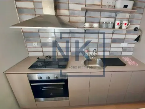 Small kitchen with built-in oven, hob, sink, and extractor hood. - image 3