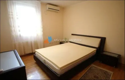 Furnished bedroom with a double bed and a window. - image 13