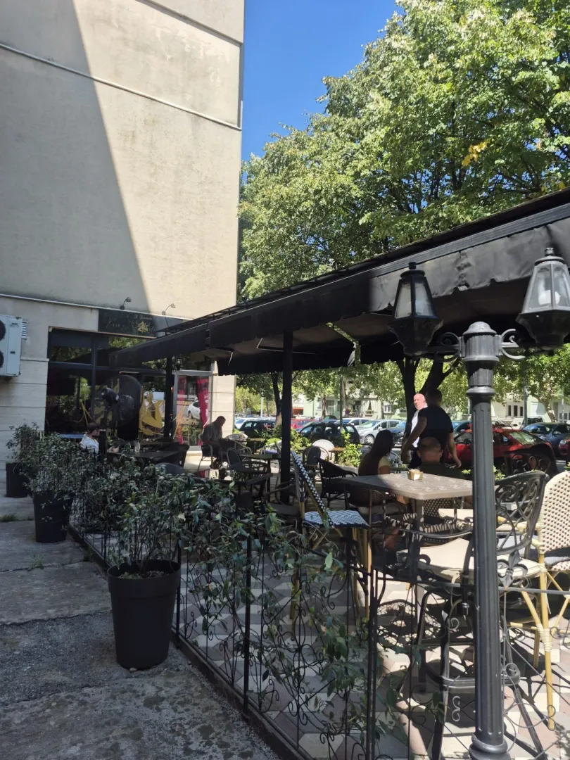 Outdoor terrace of a commercial property with shaded seating.
