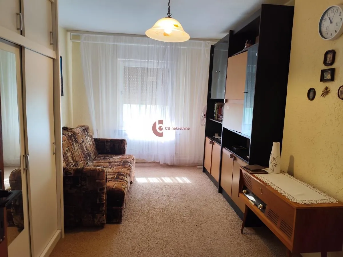 Living room with a sofa, wardrobe and wall unit furniture.