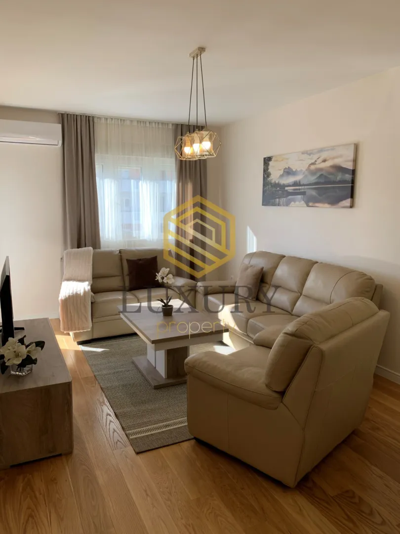 Living room with sofa set, coffee table and TV unit.