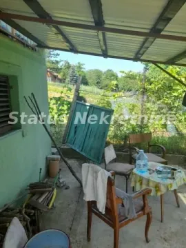 Covered patio area with a table, chairs, and a view of greenery. - image 28