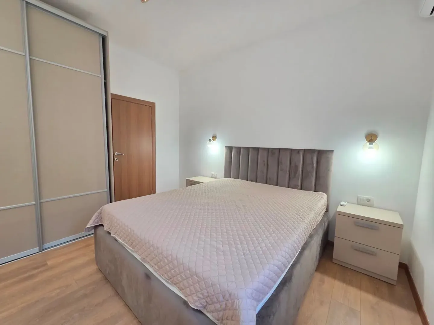 Furnished bedroom with a double bed, wardrobe, and nightstands.