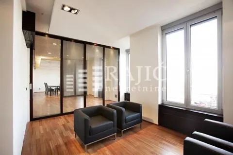 Living room with black leather armchairs and hardwood flooring. - image 3
