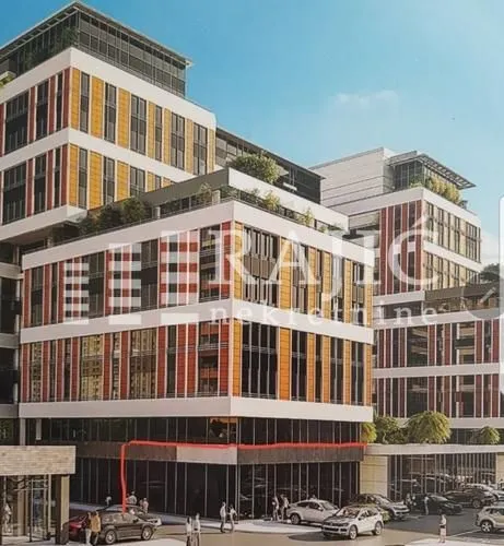 Exterior view of a modern multi-story building with terraces and ground-floor parking.