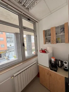 Smaller kitchen with a window, cabinets, and a work desk. - image 6