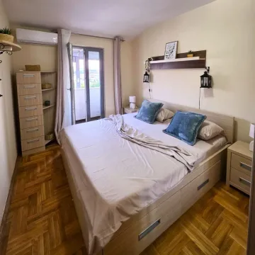 Furnished bedroom with a double bed, wooden flooring, and access to the terrace. - image 5
