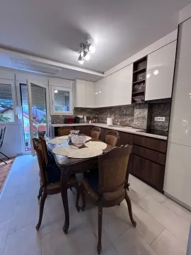 Modern kitchen with a dining area and access to the terrace. - image 4