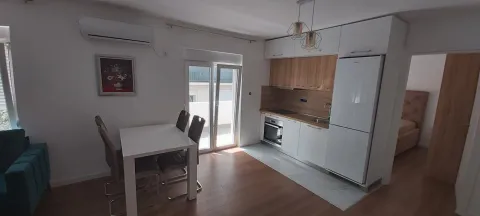 Modern kitchen with a dining table and built-in appliances. - image 2