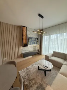Modern living room with a sofa, TV, and dining table. - image 4