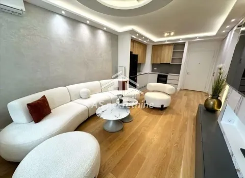 Living room with a sofa set and a view towards the kitchen in the background. - image 4