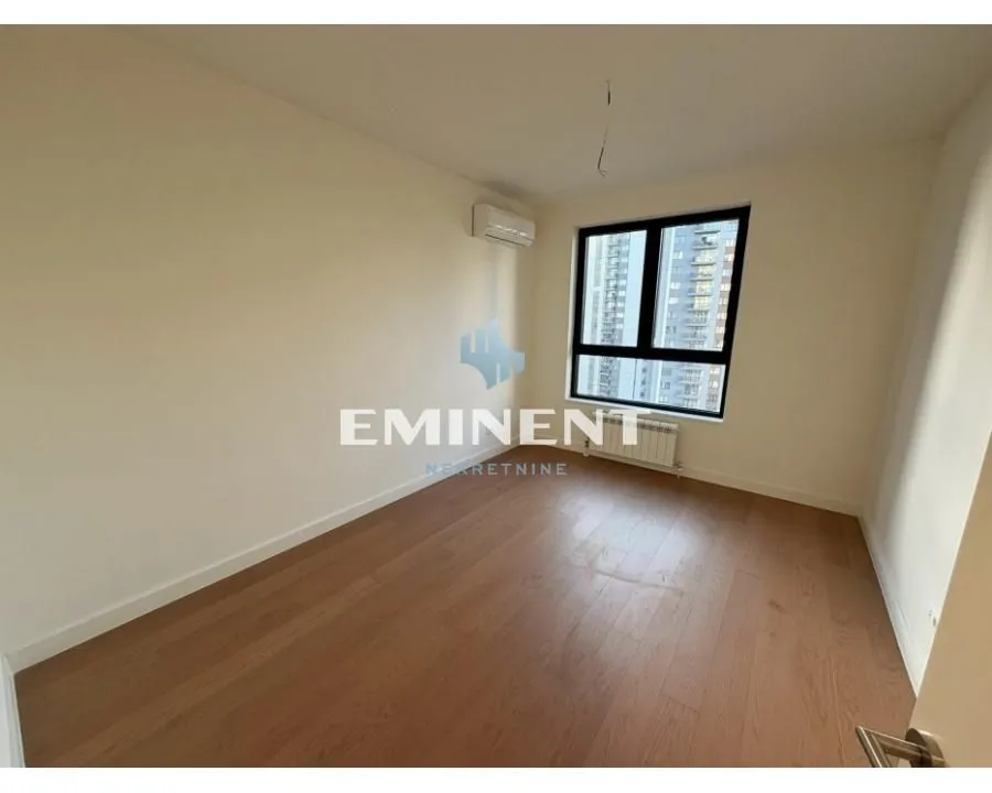 Empty room with hardwood floors and a window.