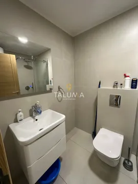 Modern bathroom equipped with a washbasin and a wall-mounted toilet. - image 4