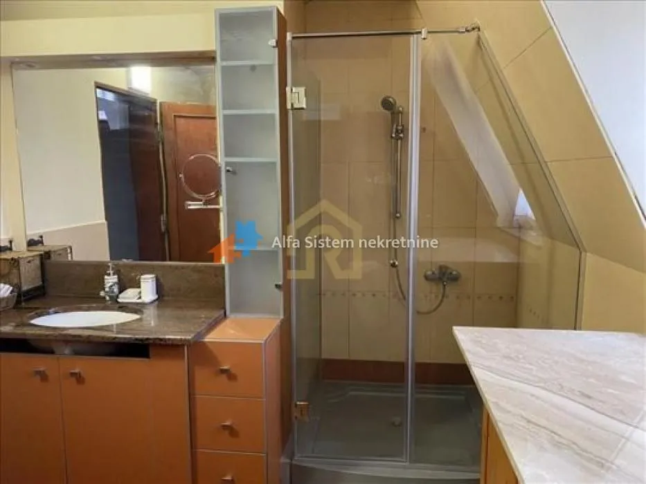Bathroom with a sink and a shower cabin.