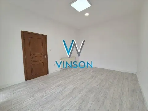 Empty room with light laminate flooring and a wooden door. - image 5