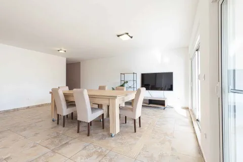 Spacious living room with a dining table and a television. - image 7