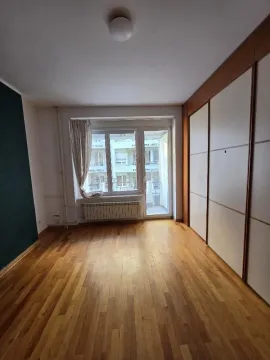 Empty room with hardwood flooring, large built-in wardrobe, and access to a balcony. - image 12