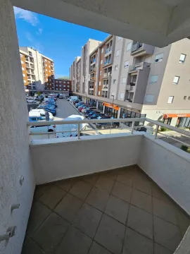 View from the balcony overlooking the parking lot and surrounding residential buildings. - image 11