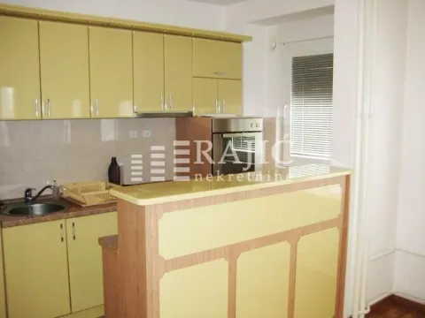 Smaller kitchen with yellow cabinets and a breakfast bar. - image 4