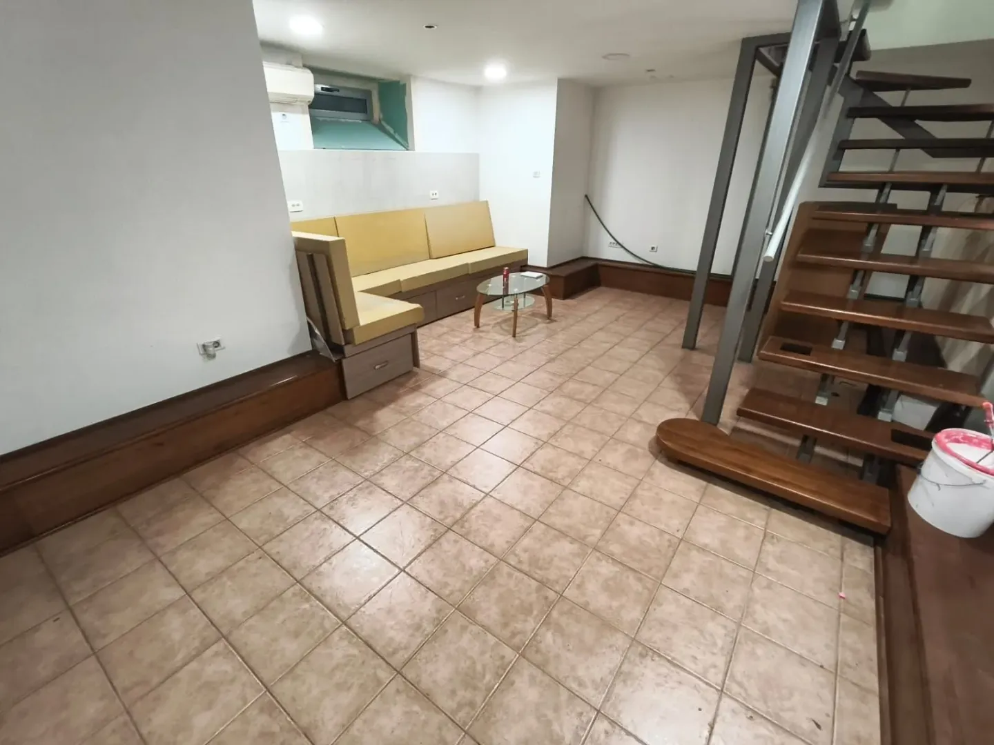 Living room with a sofa set and a staircase.