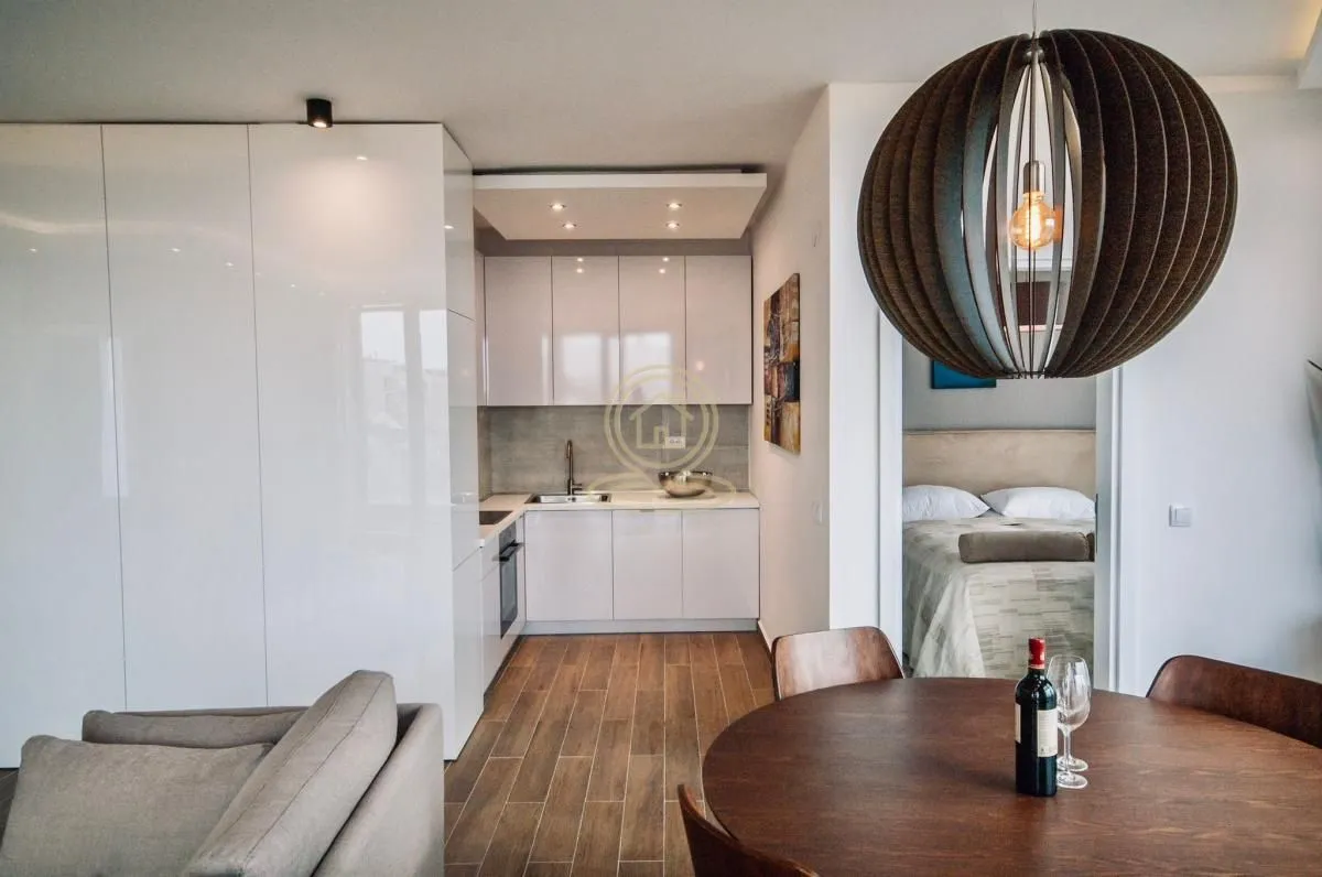 Living room with dining area and kitchen in the background.