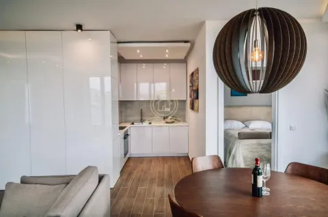 Living room with dining area and kitchen in the background. - image 3