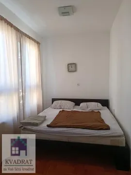 Bedroom with a double bed and a window covered with curtains. - image 5