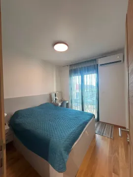 Furnished bedroom with a double bed and terrace access. - image 5