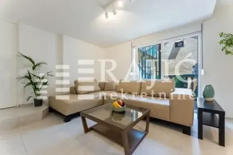 Bright living room with a sectional sofa and a coffee table. - image 4