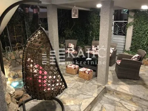 Lanscaped courtyard with seating furniture and a hanging chair. - image 18